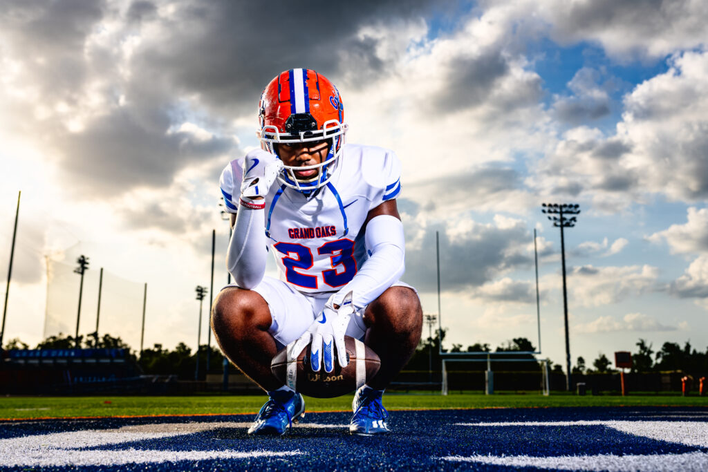 football player crouching with ball by Seth Fontenot