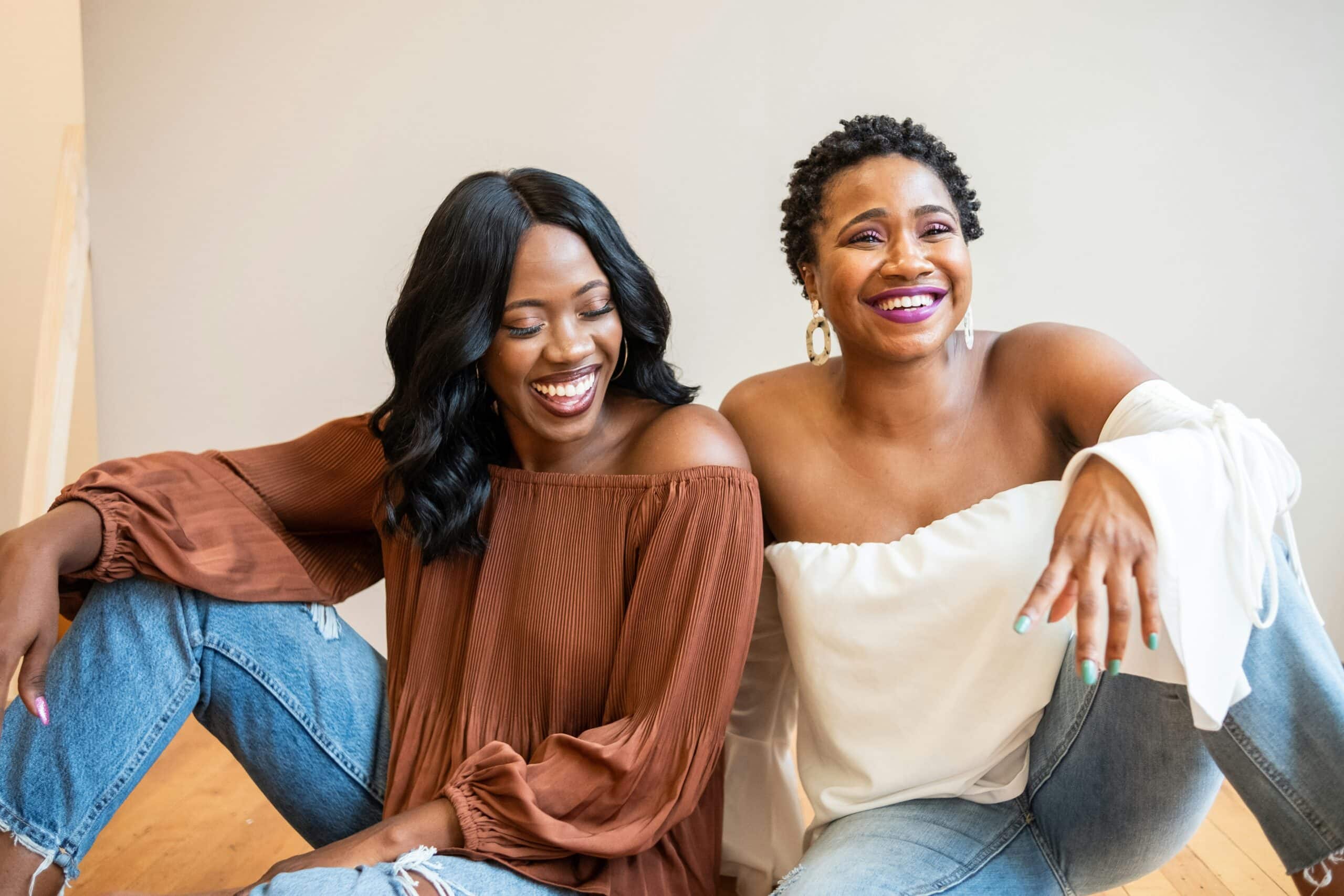 two sisters laughing and smiling in photography studio