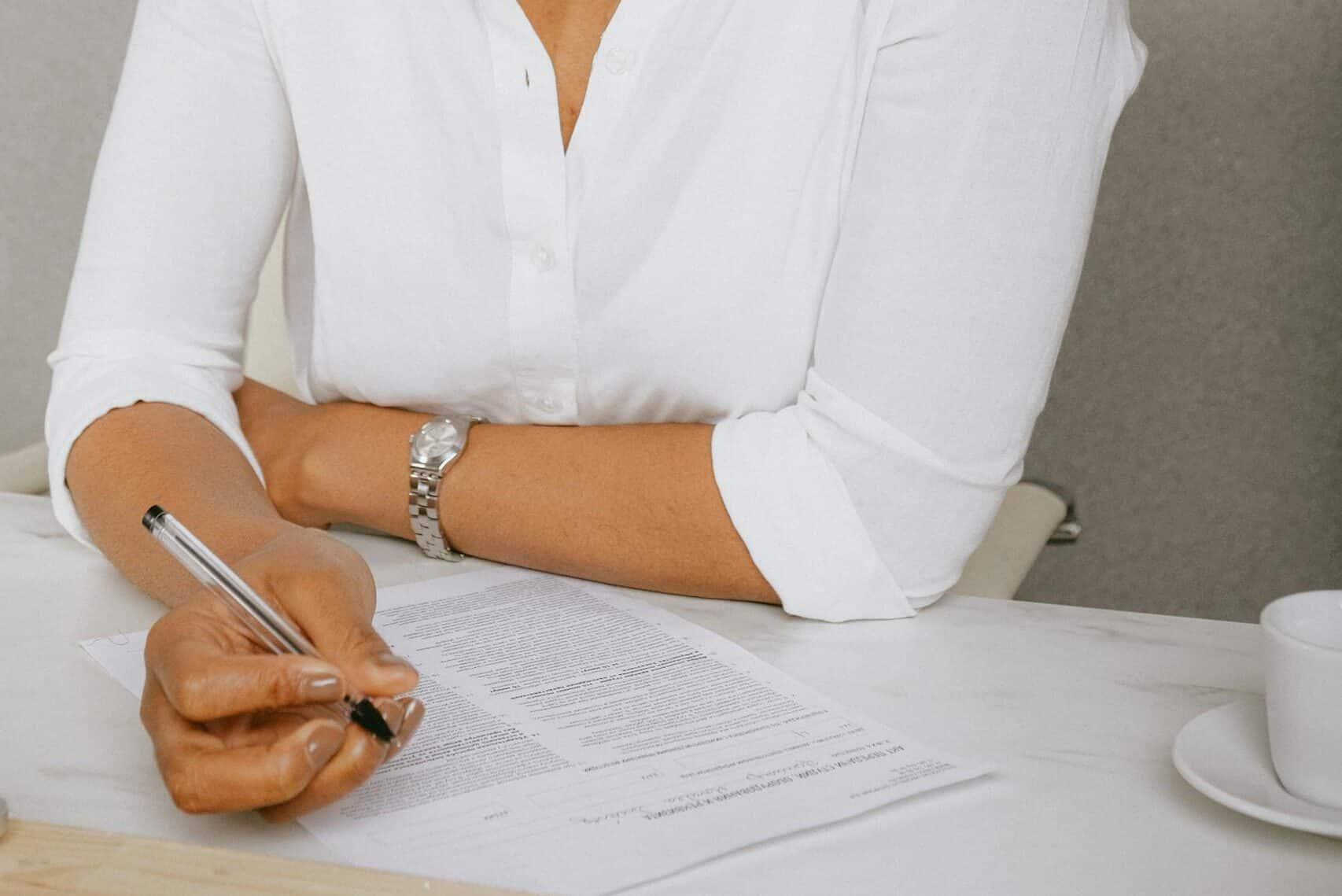 woman in white shirt reviewing contract
